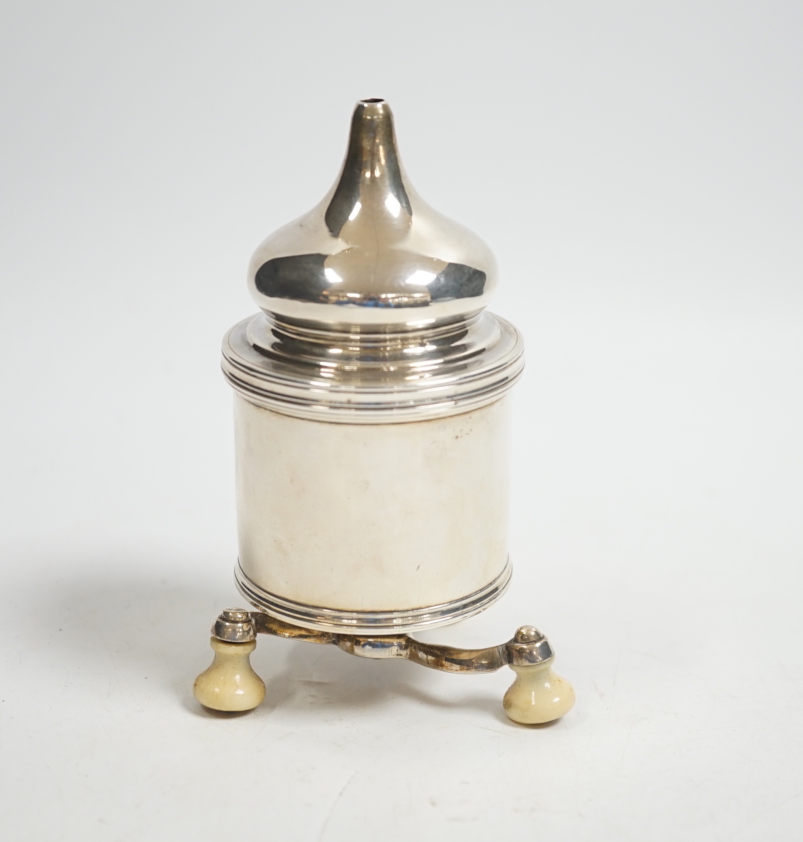 A French white metal pepper grinder on three ivory feet, height 11.5cm CITES Submission reference: JWYF7WUN